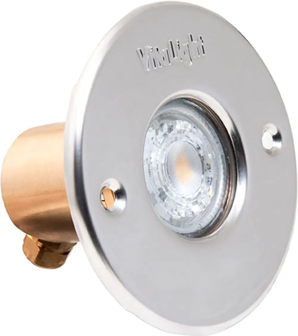 Edelstahlblende mit integrierter LED-Lampe, hergestellt von Grünbeck. Sie ist rund mit einer klaren Linse und wird möglicherweise für Boden- oder Wandinstallation genutzt.